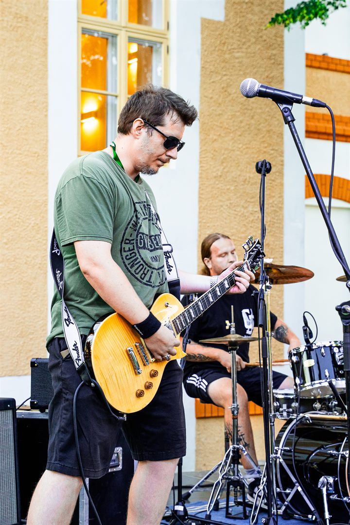Guitarist and drummer performing live with Diamond