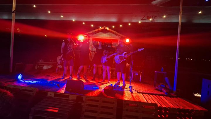 Diamond performing under red stage lights